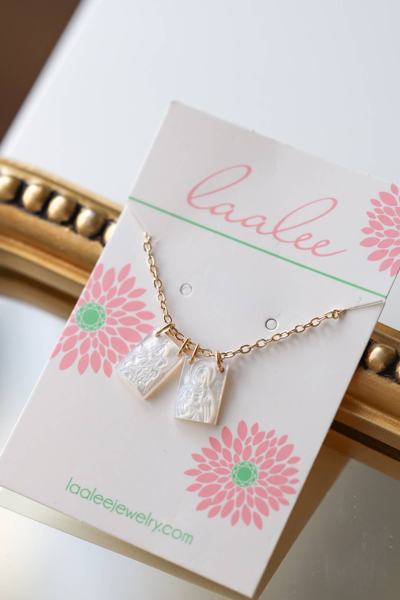 Scapular on a 'Laalee' branded card with floral design