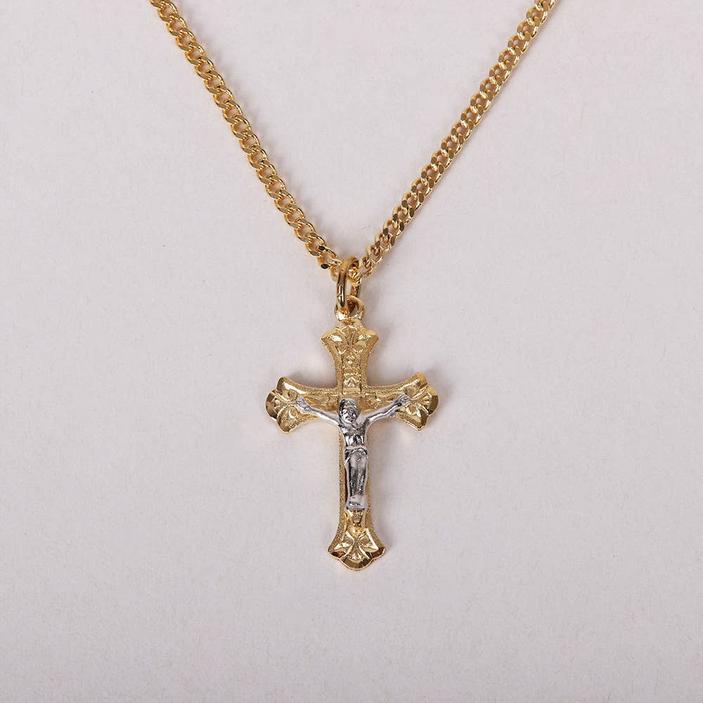 Gold cross necklace with Jesus pendant on a light gray background
