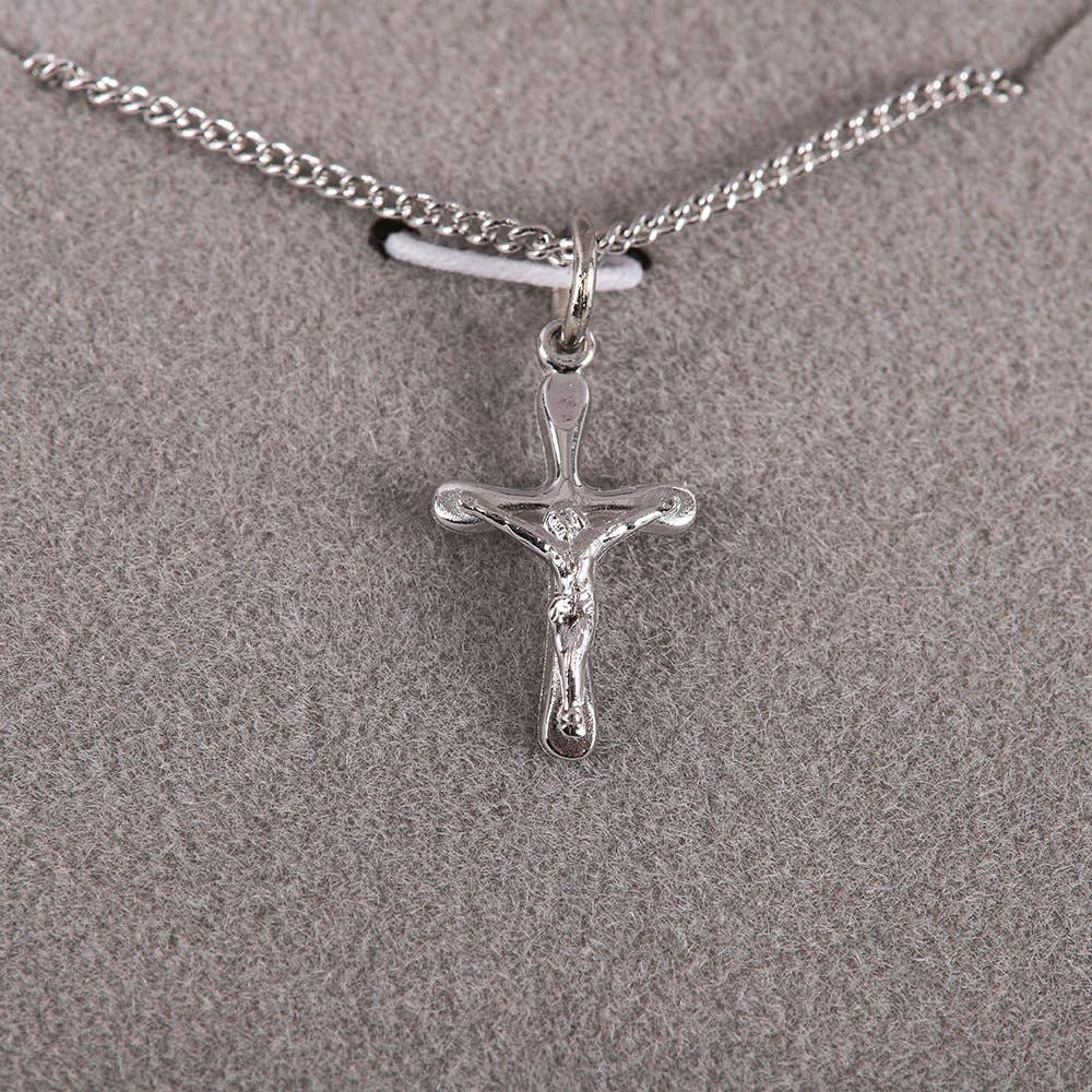 Silver crucifix pendant on a chain against a gray background