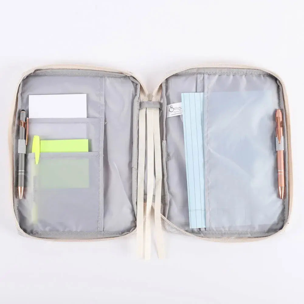 Open Bible cover organizer with compartments for notes, pens,  on a white background