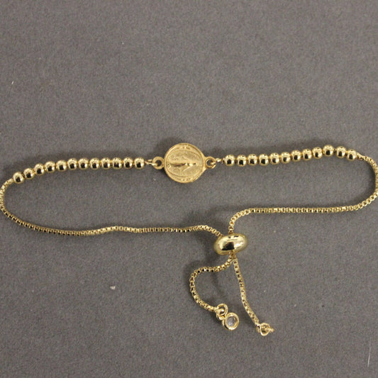 Gold bracelet on a gray background
