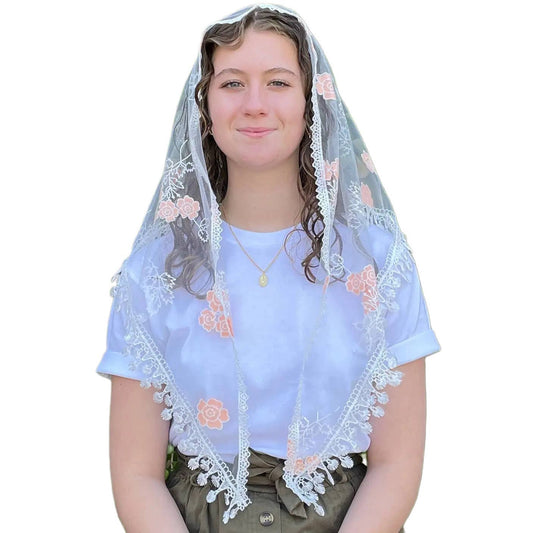 Person wearing a white embroidered veilwith floral patterns on a plain background