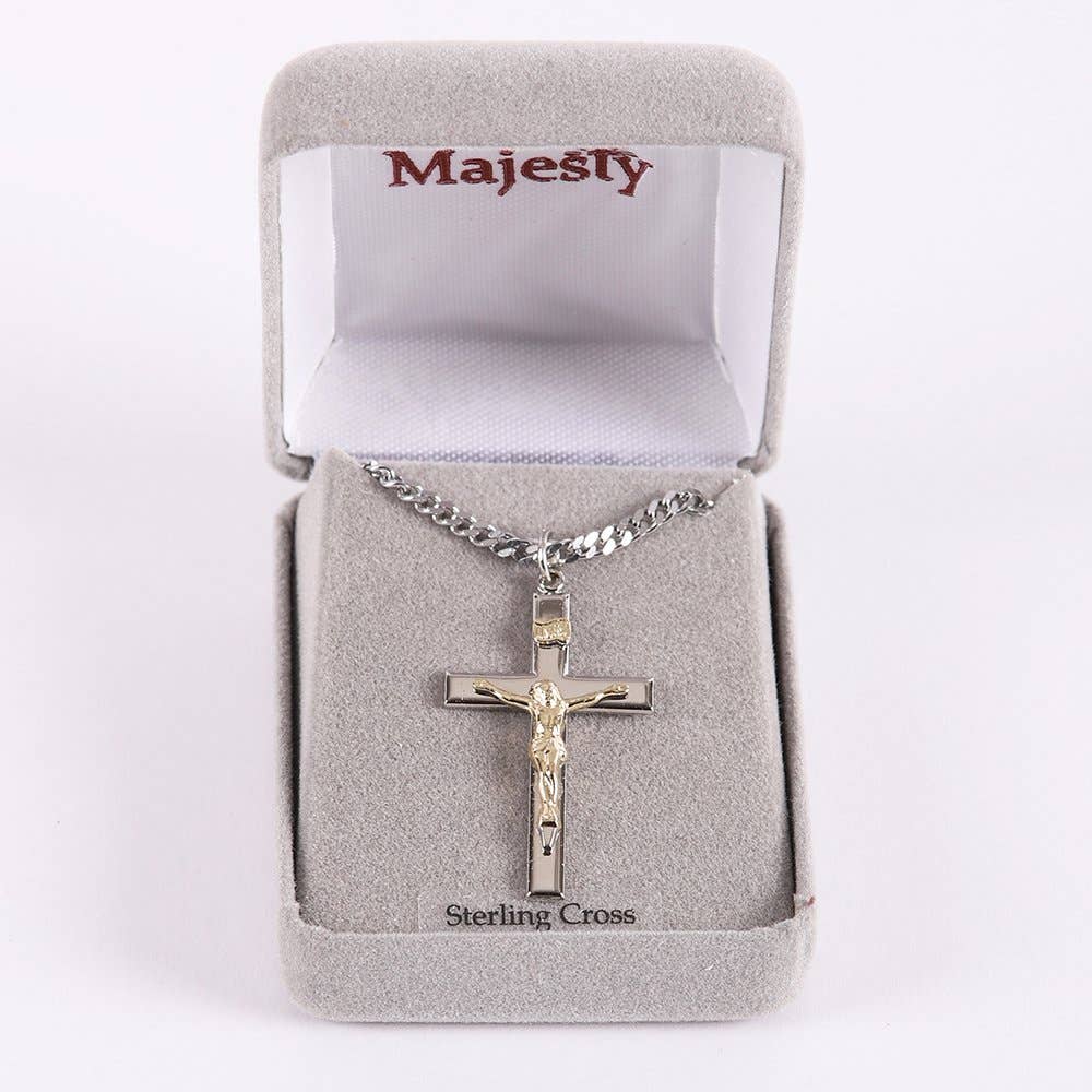 Silver crucifix necklace in a 'Majesty' branded box on a white background