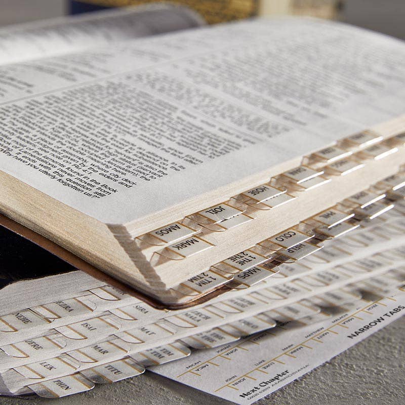 Open book with index cards on top, used for studying or reference.