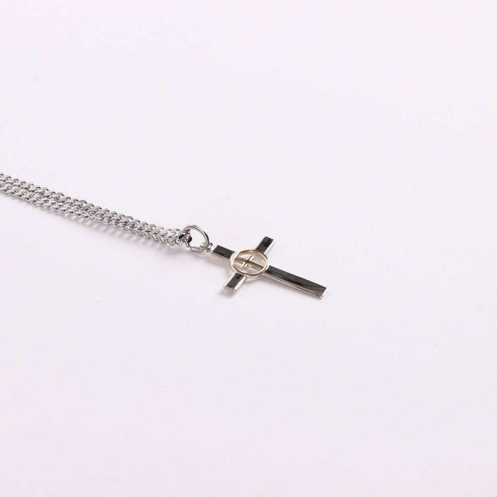 Silver chain necklace with a cross pendant on a white background