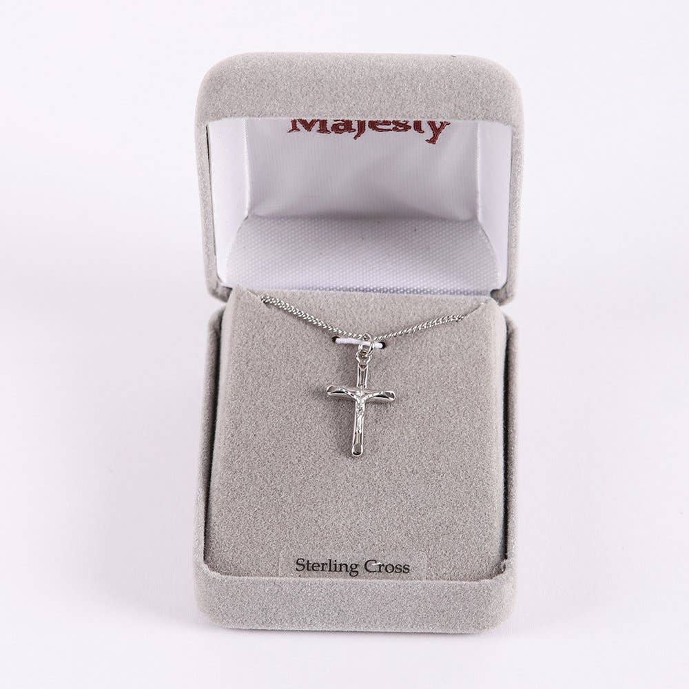 Silver cross necklace in a Majesty jewelry box on a white background